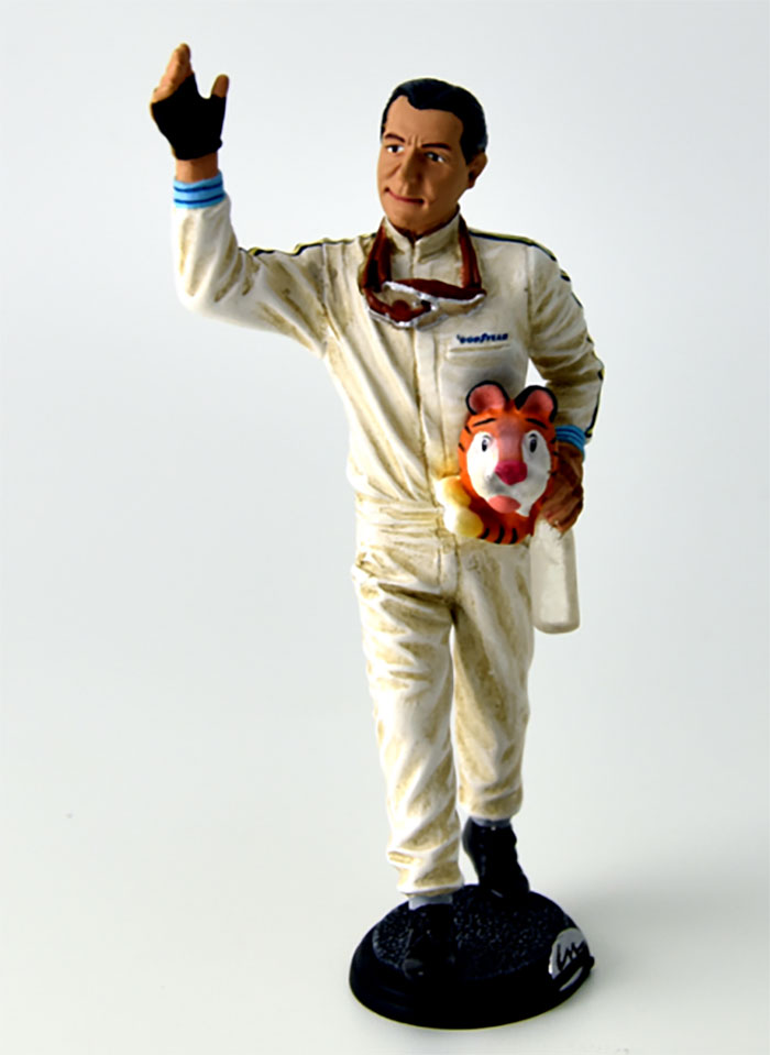 1966 Jack Brabham waving to fans with mascot in hand figurine