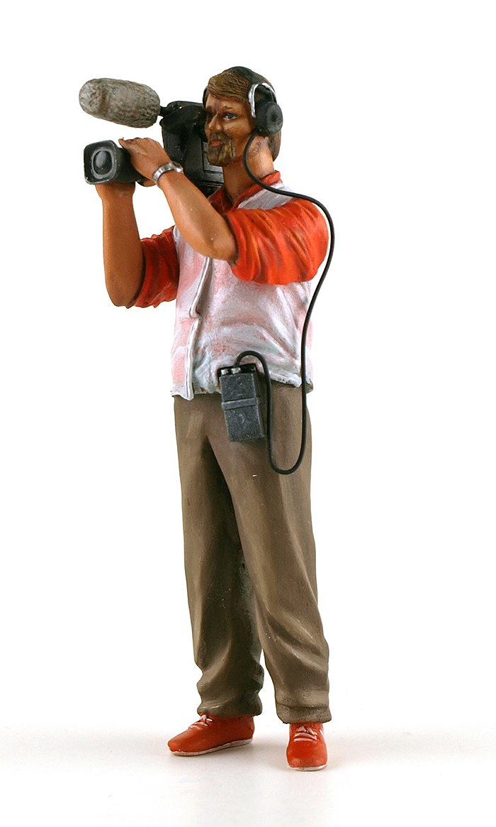 1970's Camerman, video camera on right shoulder wearing headphones